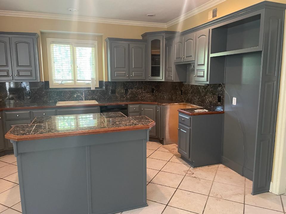 Gray kitchen with granite countertops and island