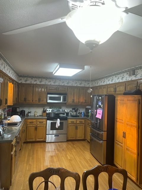 image of a kitchen with brown cabinets