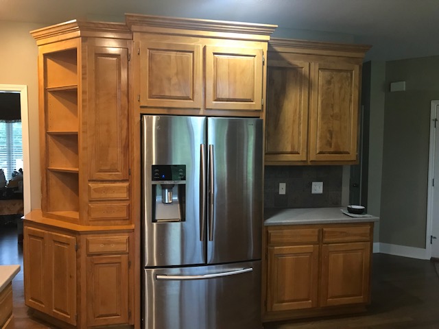 image of a kitchen with brown cabinets