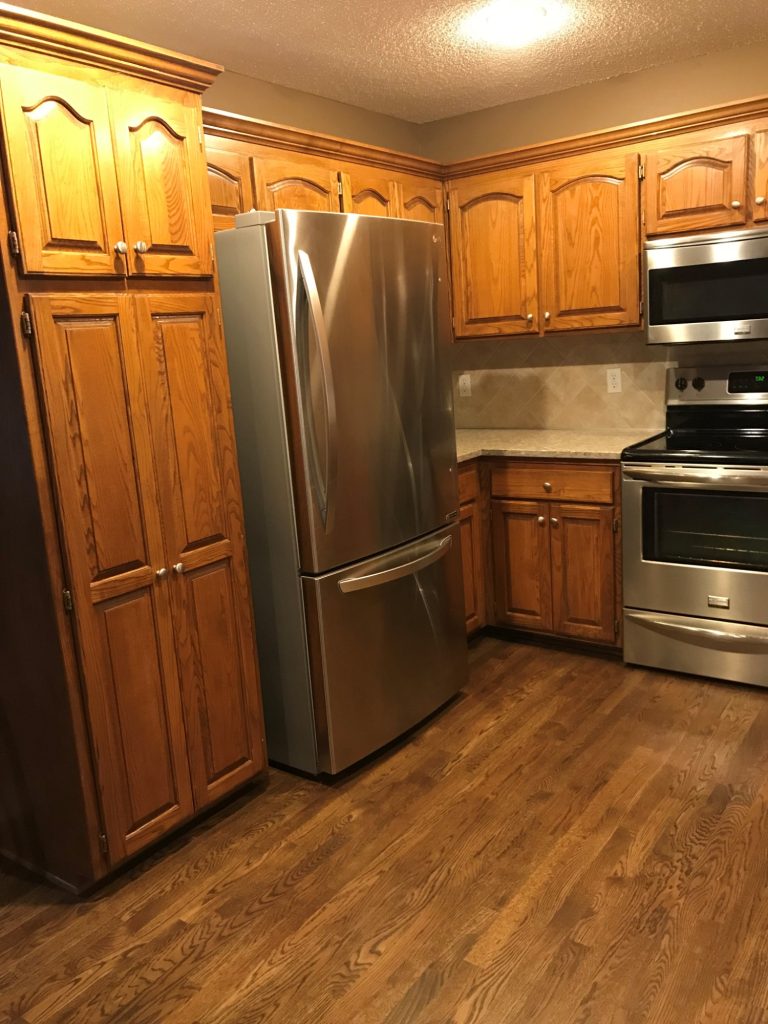 image of a kitchen with brown cabinets