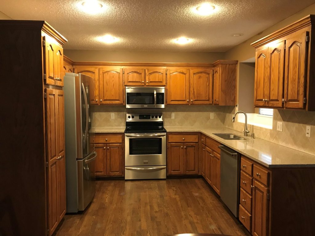 image of a kitchen with brown cabinets