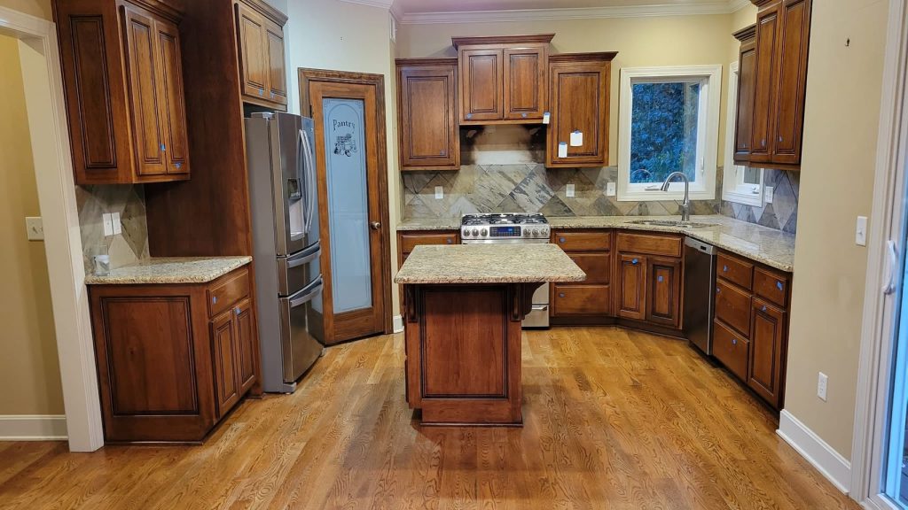 image of a kitchen with brown cabinets