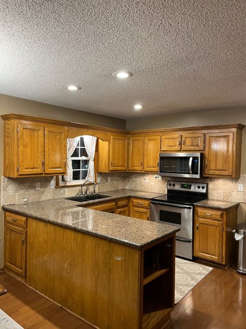 image of a kitchen with brown cabinets