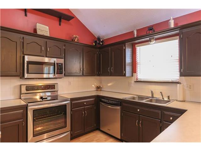 image of a kitchen with brown cabinets