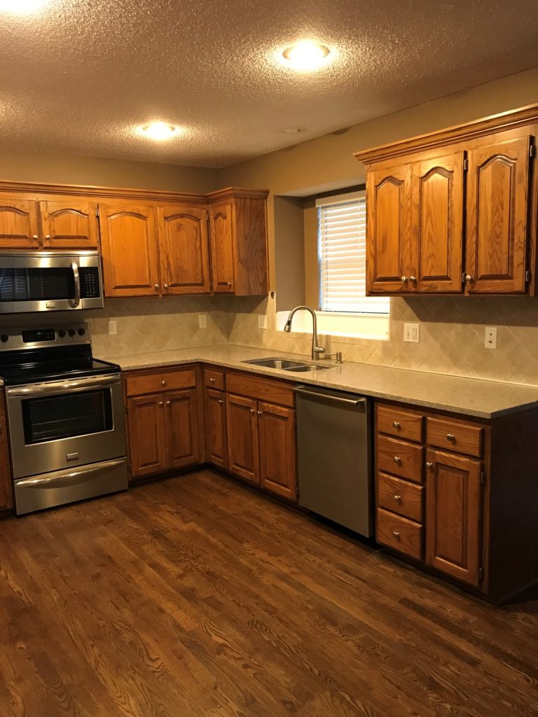 image of a kitchen with brown cabinets