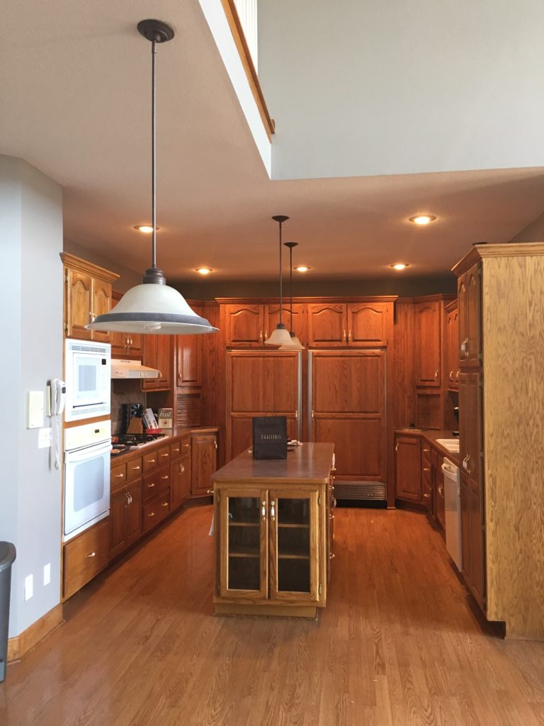 image of a kitchen with brown cabinets