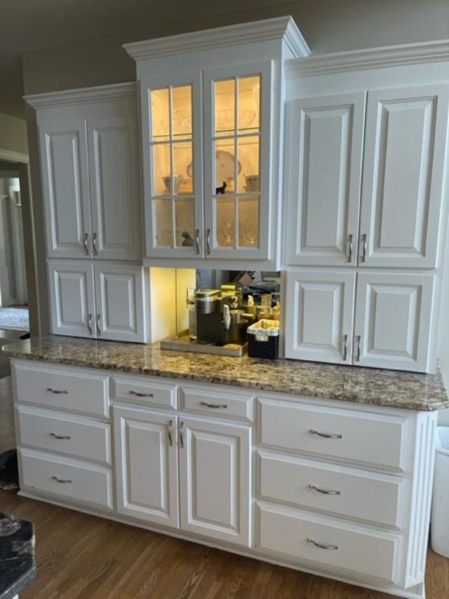 White kitchen cabinets with built-in glass showcase